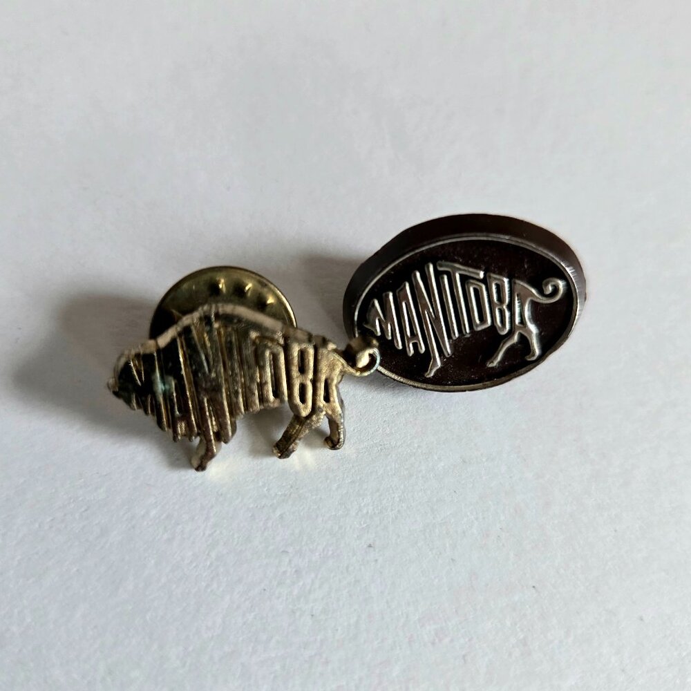 2 Manitoba metal pins.